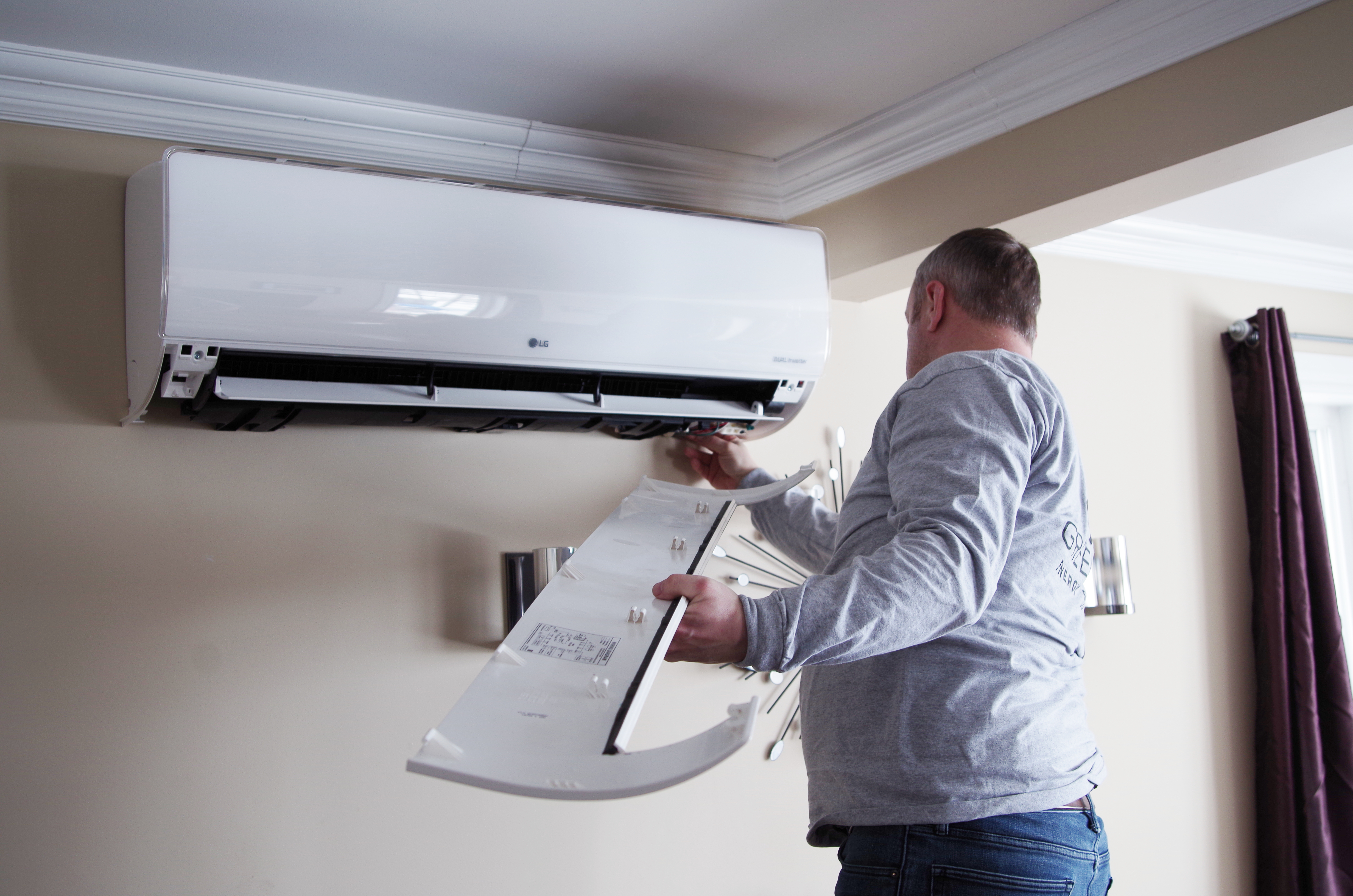 Tony Parker of Greenfoot Energy Solutions checks on a heat pump installed through NEER