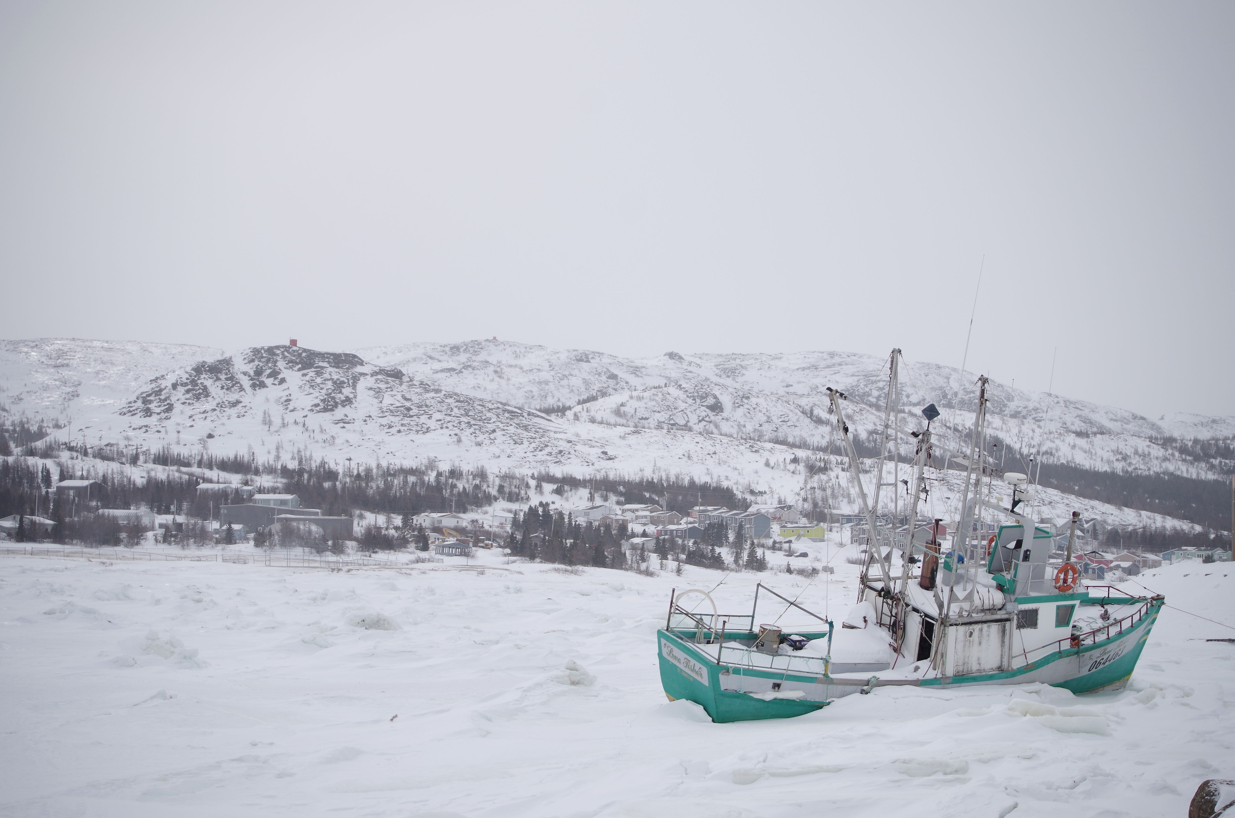 A fishing boat in Nain waits for the summer thaw of the sea ice